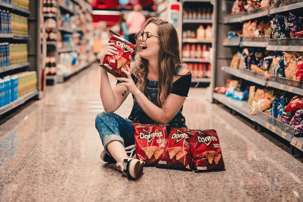 a woman stocking up on junk food