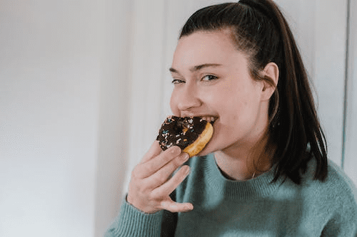 a woman eating a donut