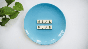 scrabble tiles on plate forming word “meal plan”